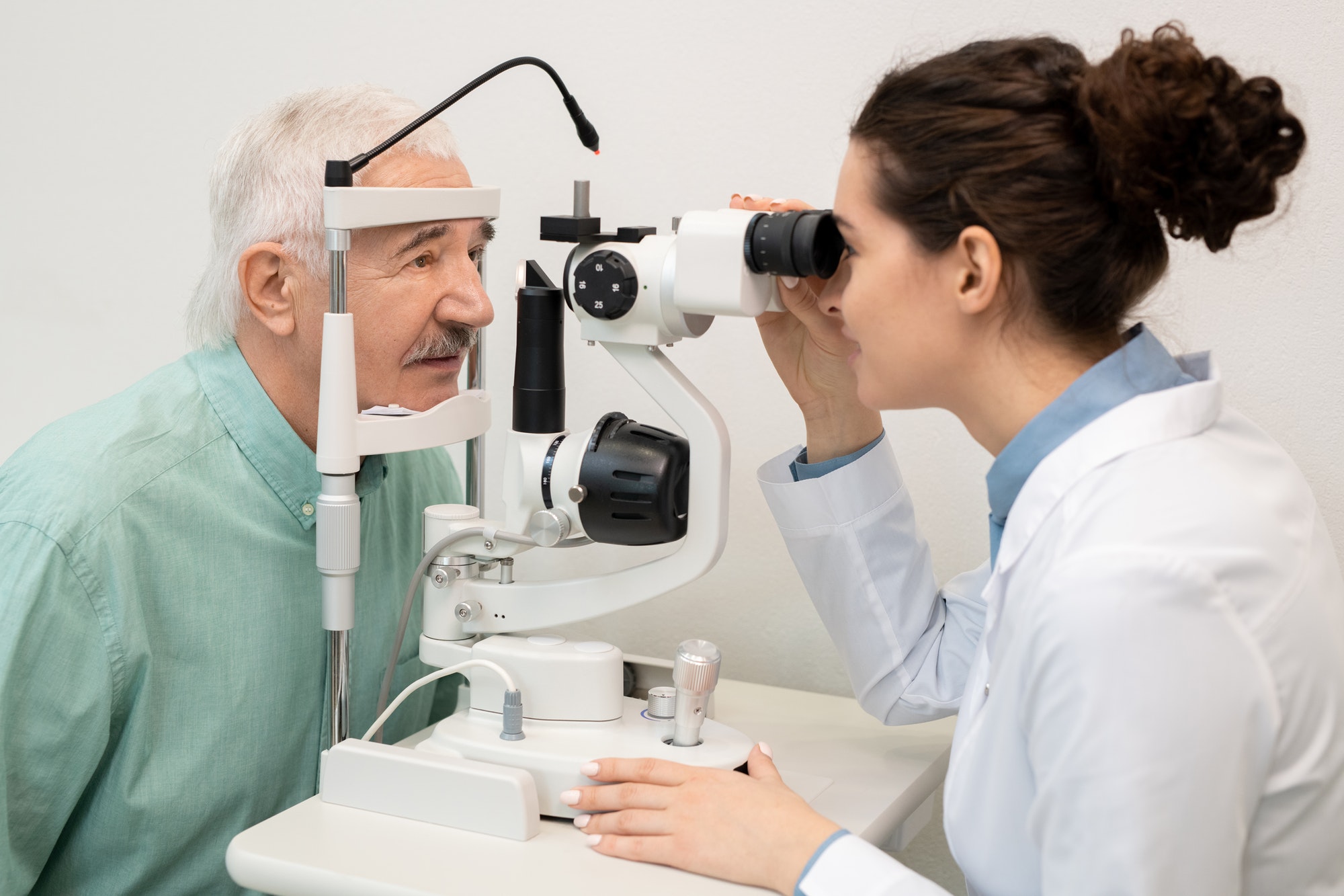 young-brunette-female-ophthalmologist-testing-eyesight-of-senior-male-patient.jpg