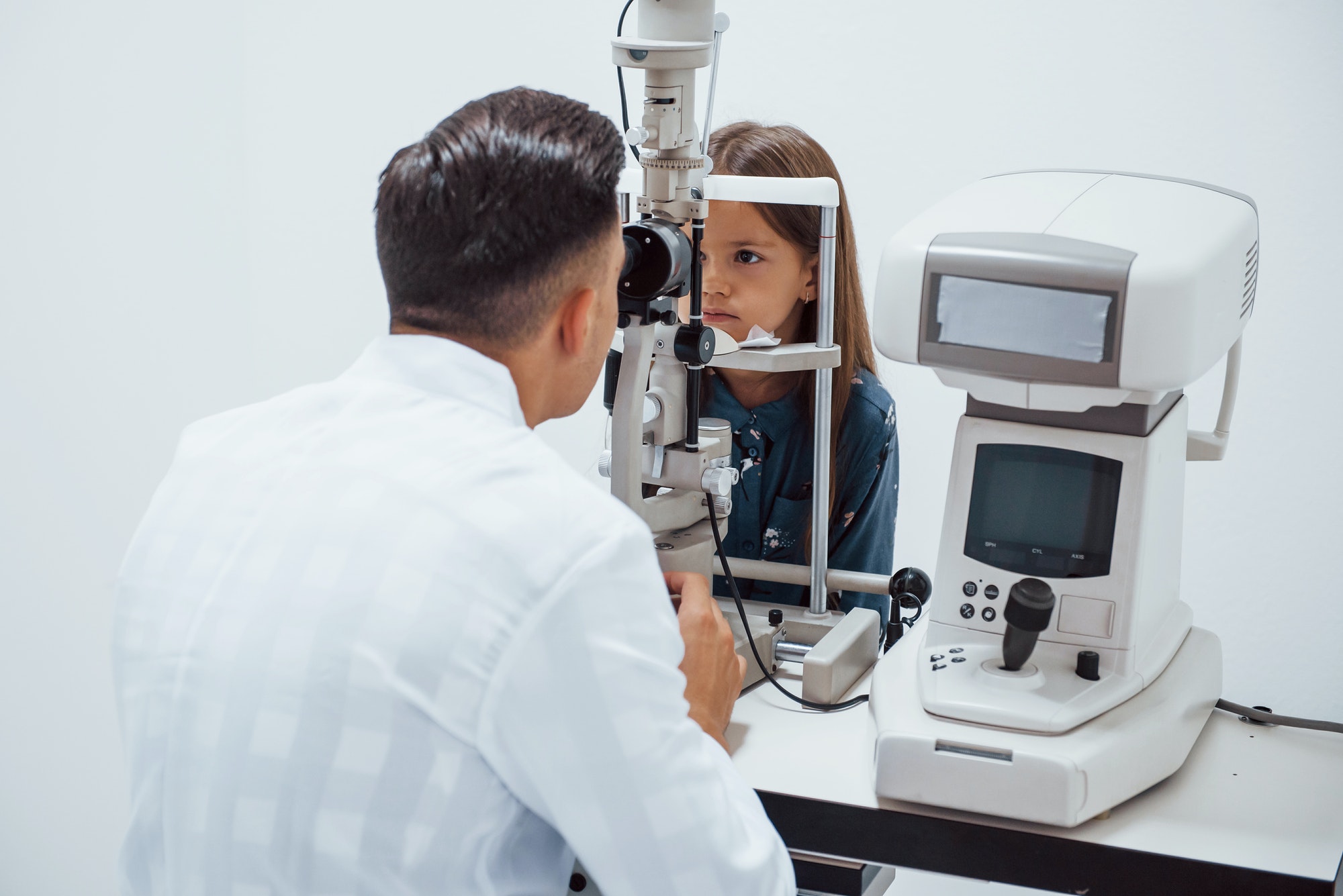 young-ophthalmologist-is-with-little-female-visitor-in-the-clinic.jpg